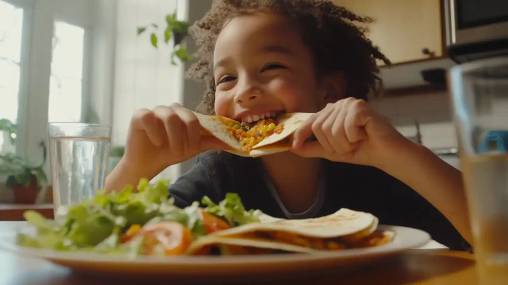 A child enjoying a quesadilla with a side salad.